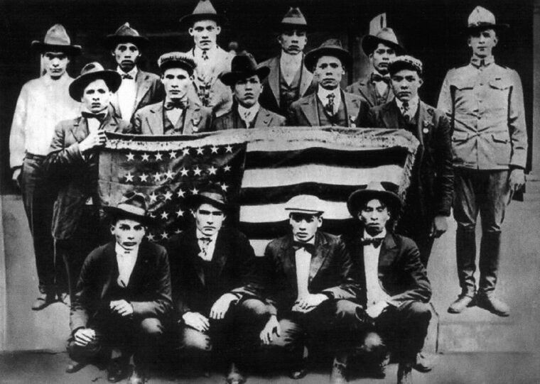 Photographed with the U.S. flag, these Choctaw served as code talkers with the American Expeditionary Force in Western Europe during World War I.