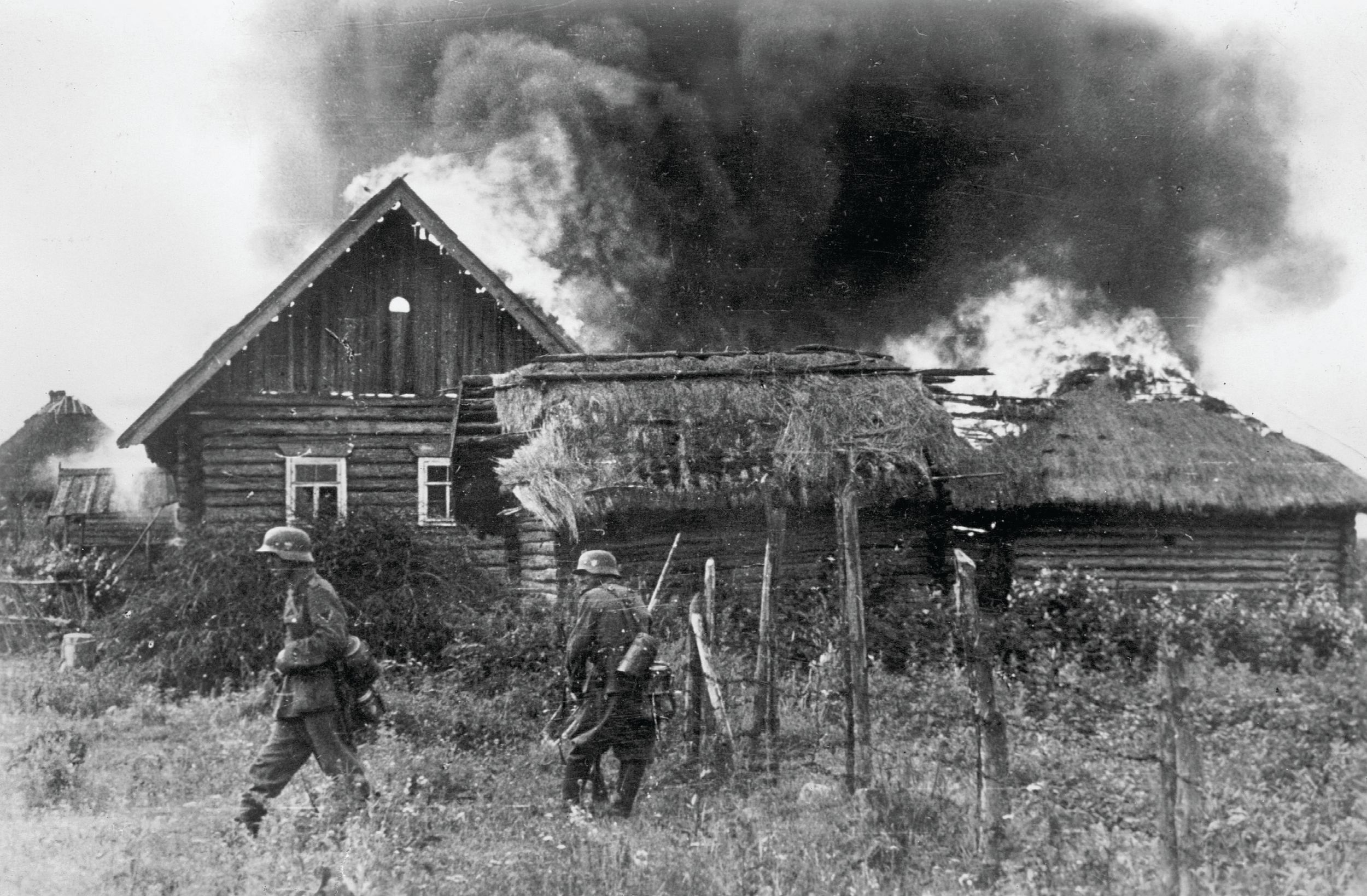 German soldiers set fire to a farm during the ruthless invasion of the Soviet Union, summer 1941. German troops and special police battalions also slaughtered Soviets in their path.
