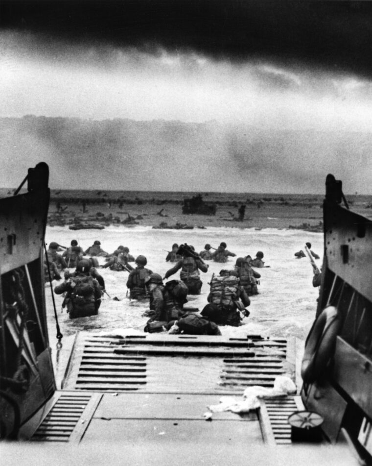 Waist-deep in water, soldiers from Company E, 16th Regiment, lead the 1st Division’s landing at Omaha Beach in this famous photo from D-Day. Heavy German machine-gun fire accompanied them every step of the way.