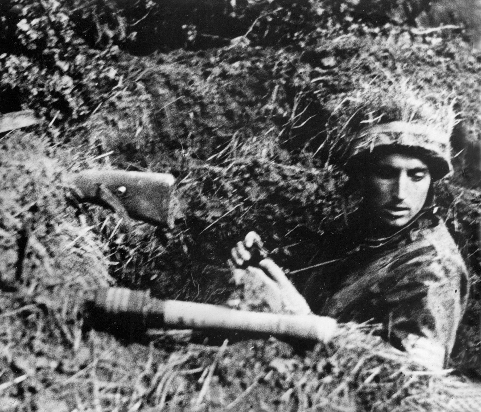 Elite German Fallschirmjagers of the 5th Parachute Division, such as this one armed with rifle and stick grenade in a foxhole, fought stubbornly against the advancing Americans.