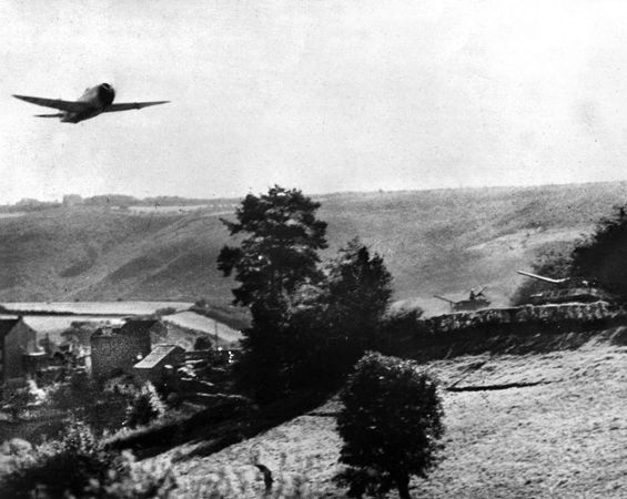 A P-47 Thunderbolt roars over a column of American tanks on a French road. Brig. Gen. Otto Weyland detailed a four-aircraft flight of P-47s to cover each of Patton’s armored columns in Brittany.
