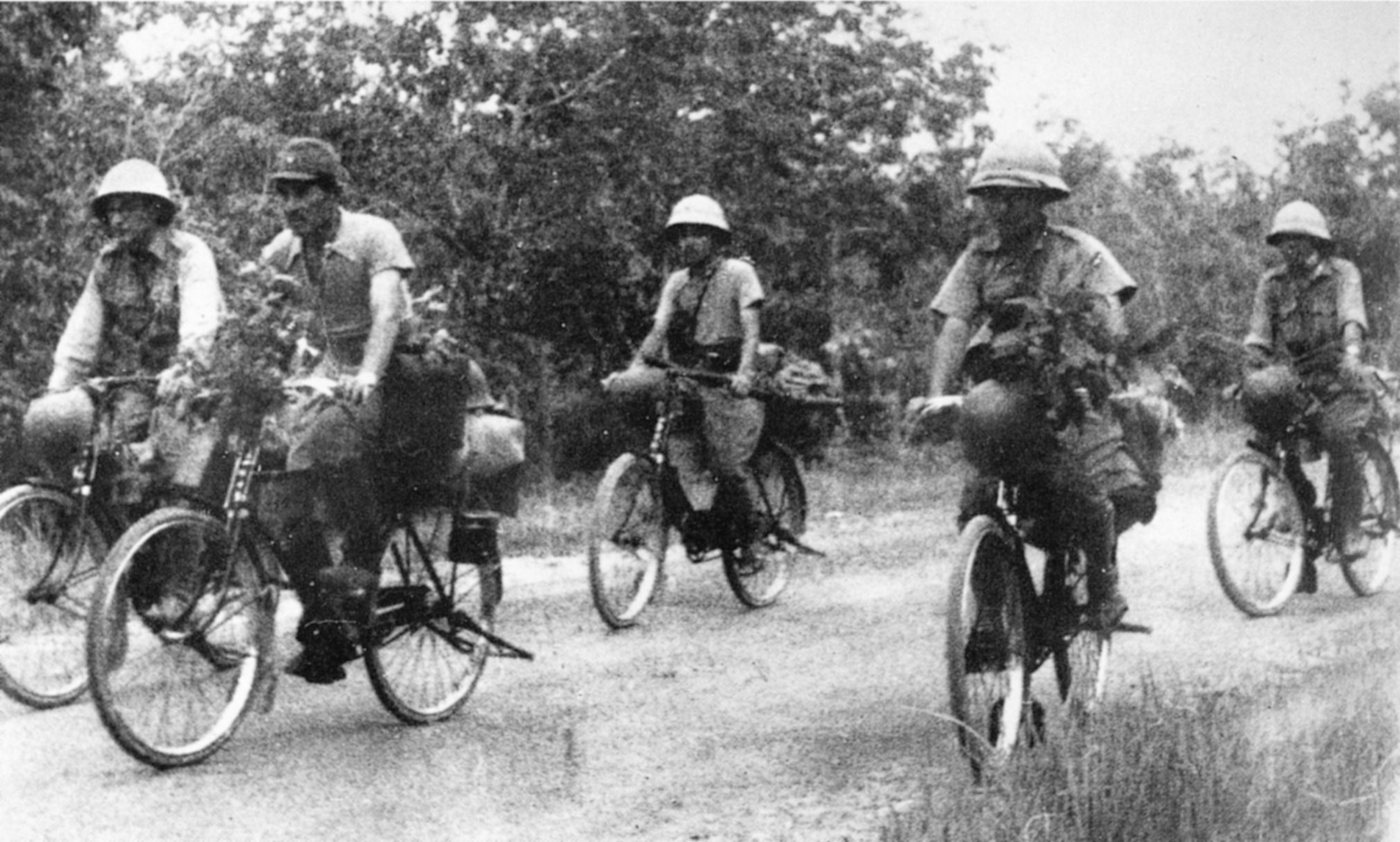 Inexorably advancing Japanese troops ride bicycles in Malaysia in 1941. Thousands poured into Singapore on such bicycles.