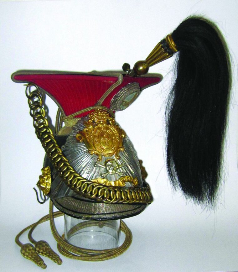 Portuguese 1852 pattern lancers officer’s cap of the Queen’s Lancers Regiment. This pattern cap was clearly influenced by the pre-1830 pattern of the British 17th Lancers, including the “flat” rayed silver plate. 