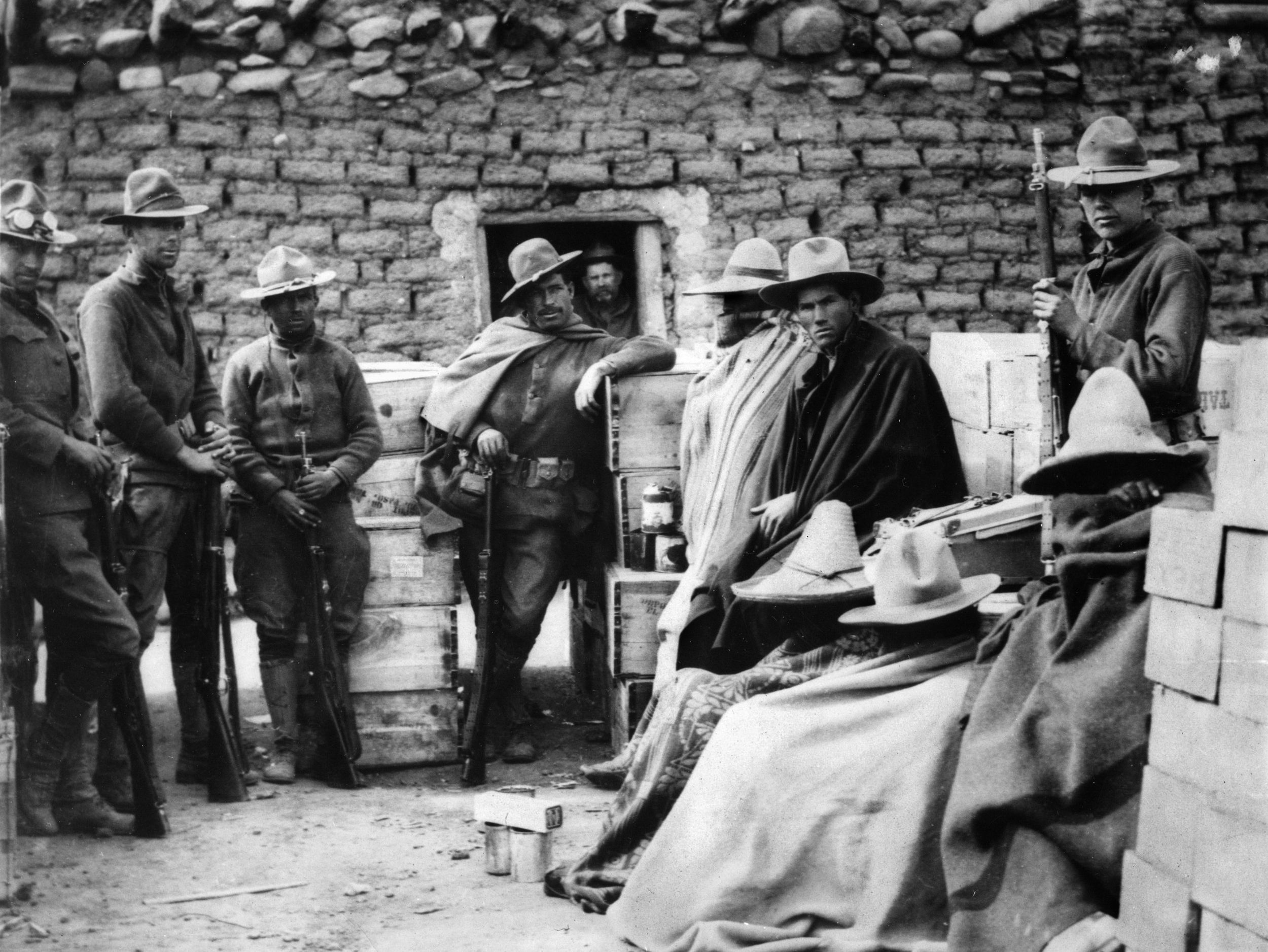 American troops guard dangerous-looking Mexican bandits captured in the mountains near Namiquipa. The bandits were among those who raided Columbus, New Mexico, with guerrilla leader Francisco “Pancho” Villa.