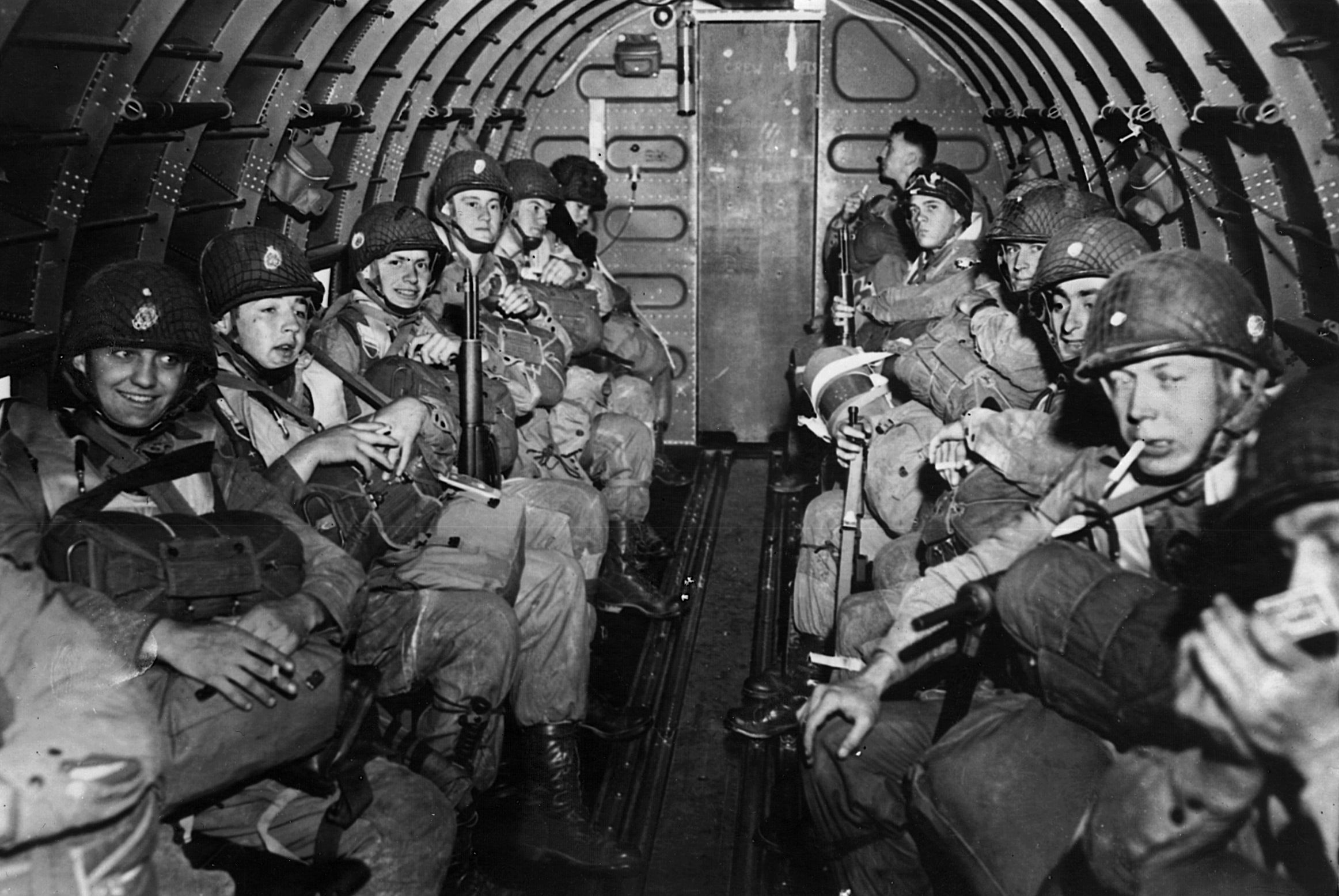 Their faces displaying a variety of emotions, these paratroopers from the 101st Airborne prepare to take off in a C-47 “Skytrain” on D-Day. 