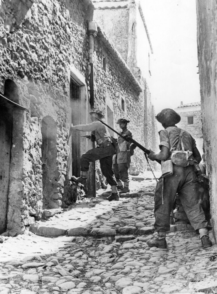 Urban fighting took place in Sicily's large cities and small villages. Here, men from the 6th Inniskillings, 38th Irish Brigade, 78th Battleaxe Division, search for enemy soldiers in a house during the battle for the town of Centuripe, August 2-4, 1943