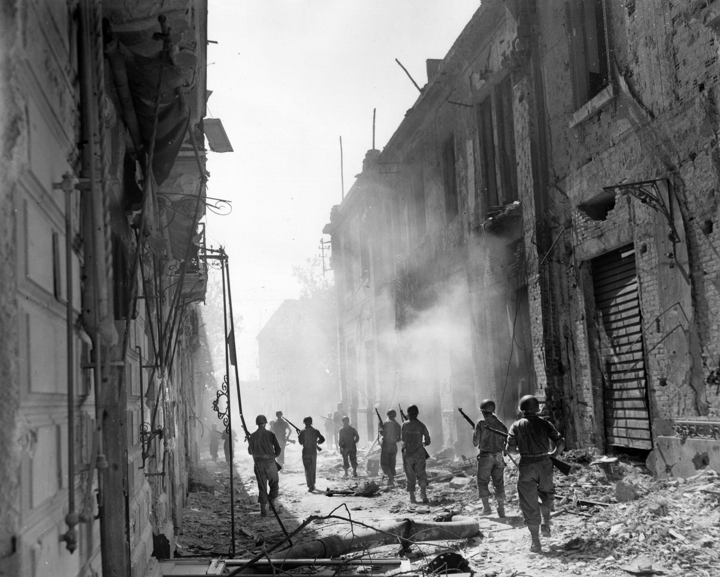 An American patrol moves through a street in Messina, August 17. More than 100,000 Axis troops escaped to fight another day in Italy. 