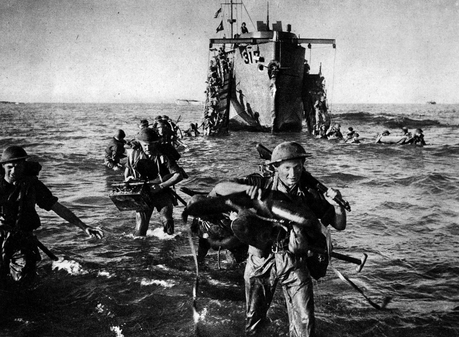 British troops wade ashore from an LCI (Landing Craft Infantry) onto one of the invasion beaches on the east coast of Sicily, July 10, 1943. Bernard Montgomery’s British Eighth Army ran into unexpectedly stiff opposition from the Germans and Italians, which slowed its progress northward. 