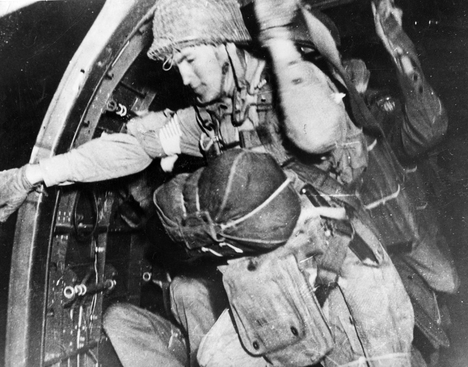 Men of the 505th Parachute Infantry Regiment, 82nd Airborne Division, begin bailing out of their transport plane. The paratroopers were to have played a key role in the invasion, but many were mis-dropped or killed by friendly fire. 