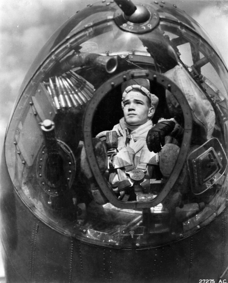 A B-26 co-pilot/bombardier poses for a photo in the bombardier’s position. Poorly fused bombs, fast speeds, low altitudes, and enemy flak and fighters contributed to less-than-satisfactory results.
