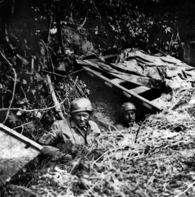 Fallschirmjägers from FJR 6 take cover in an improvised shelter on the front lines near Carentan.
