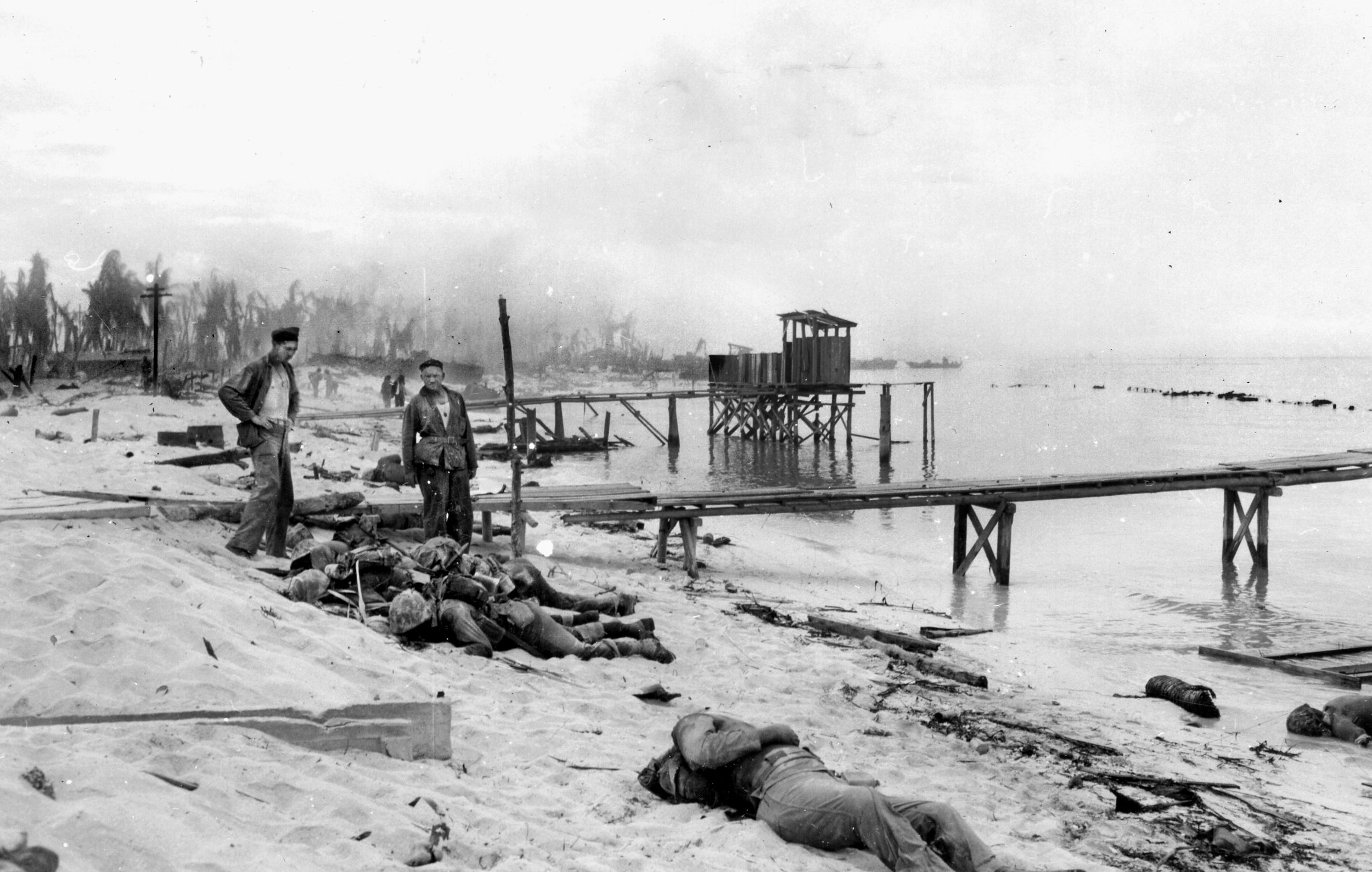 Two Marines view the carnage on the beach, where scores of Americans died even before they could fire a shot at the enemy. The taking of Tarawa resulted in one of the highest casualty tolls in the Corps’ history. 