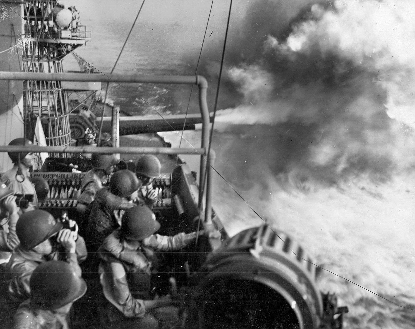 Rear Adm. Harry W. Hill (lower left) and his staff observe the pre-invasion bombardment from the 16- inch main guns of the cruiser USS Maryland, a survivor of Pearl Harbor. The well-dug-in defenders shrugged off the heavy shelling and came out fighting. 