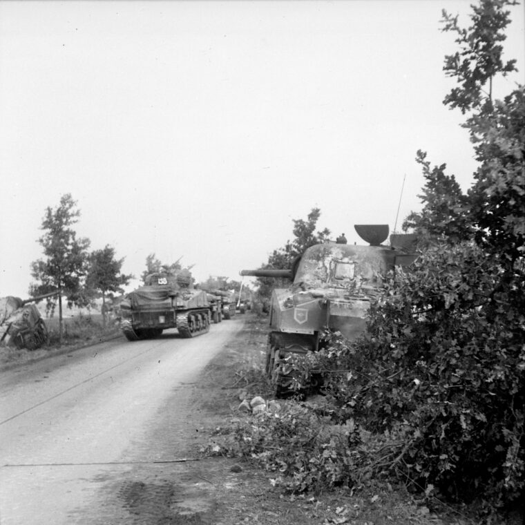 In this photo taken on September 17, 1944, Sherman tanks of the Irish Guards advance warily past other vehicles disabled during fighting with the Germans earlier in the day. The advance of 30th Corps was slowed considerably by German resistance and the single usable road.