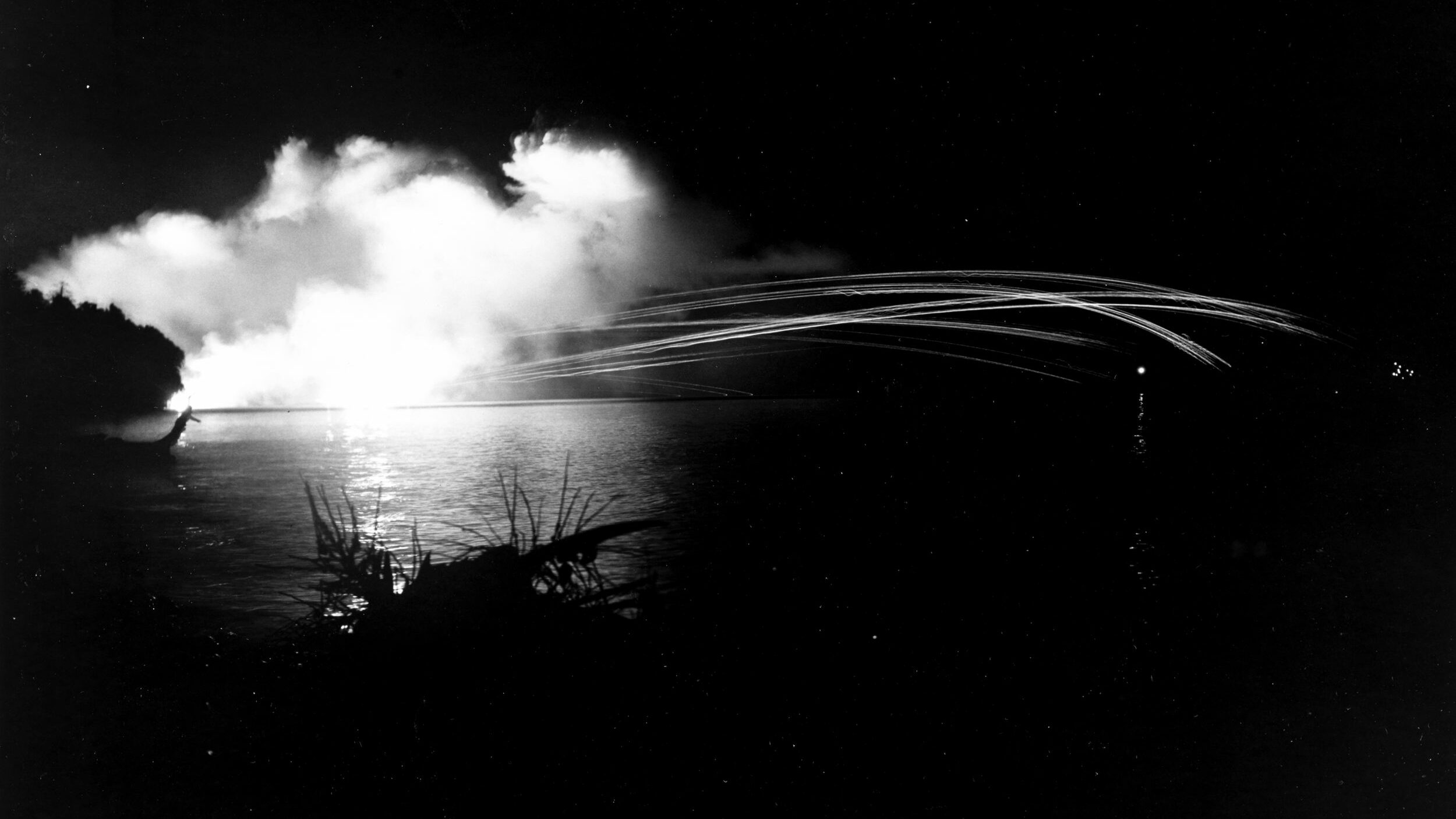 U.S. Navy warships of Admiral A.S. Merrill’s Task Force 68 shell the airfield at Munda on the island of New Georgia in July 1943. Cleveland-class light cruisers often took part in shore bombardment operations.