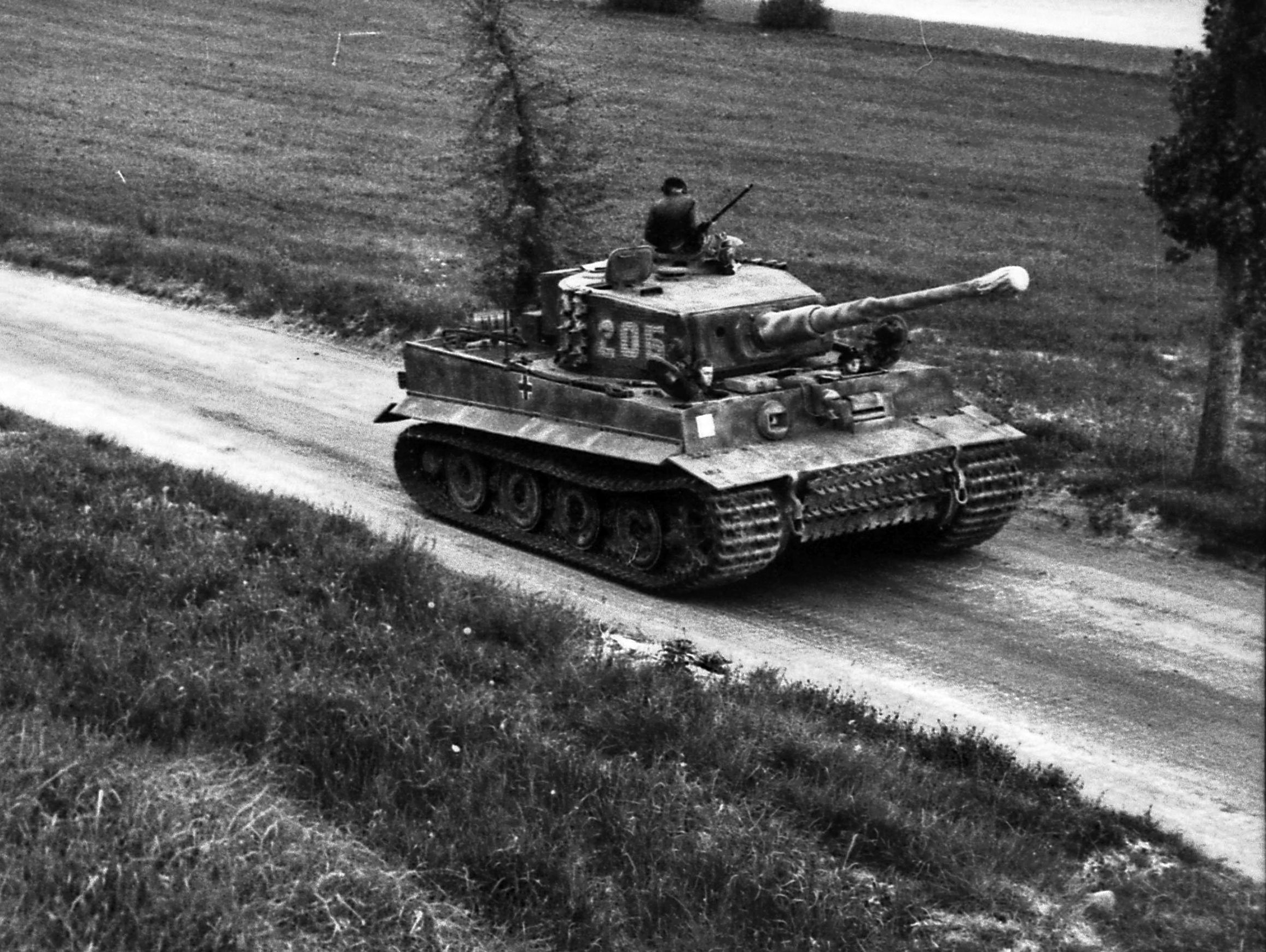 SS Lieutenant Michale Wittman’s Tiger tank, No. 205 , 2nd Company, 101st SS Heavy Tank Battalion, is shown advancing along a road in Normandy in early June, 1944. Wittman gained fame in the fighting at Villers-Bocage.