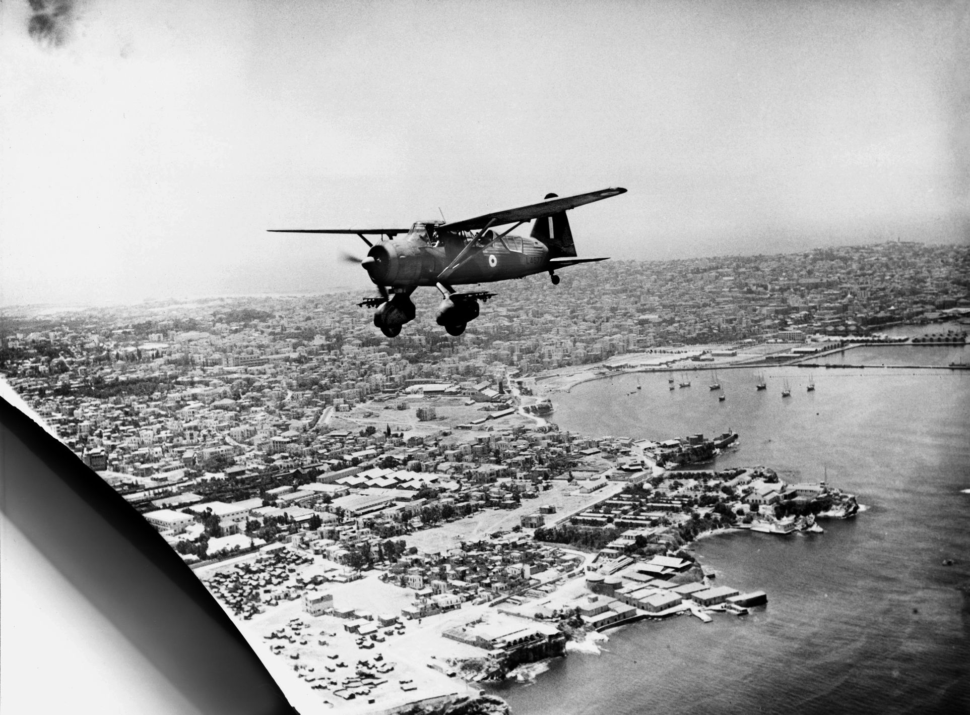 An RAF Westland Lysander Mark I flies over the Beirut waterfront shortly after the city fell to the British in July 1941.