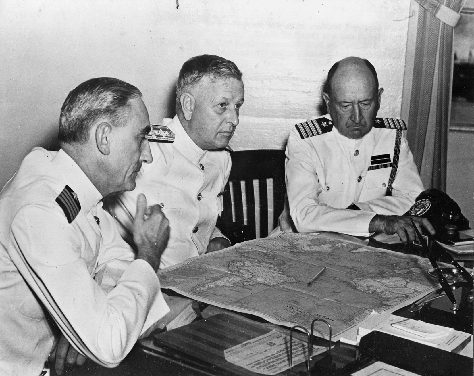 Admiral Husband E. Kimmel, USN, center, confers with his operations officer, Captain W.S. Stanley (left) and his chief of staff, Captain William W. Smith. 