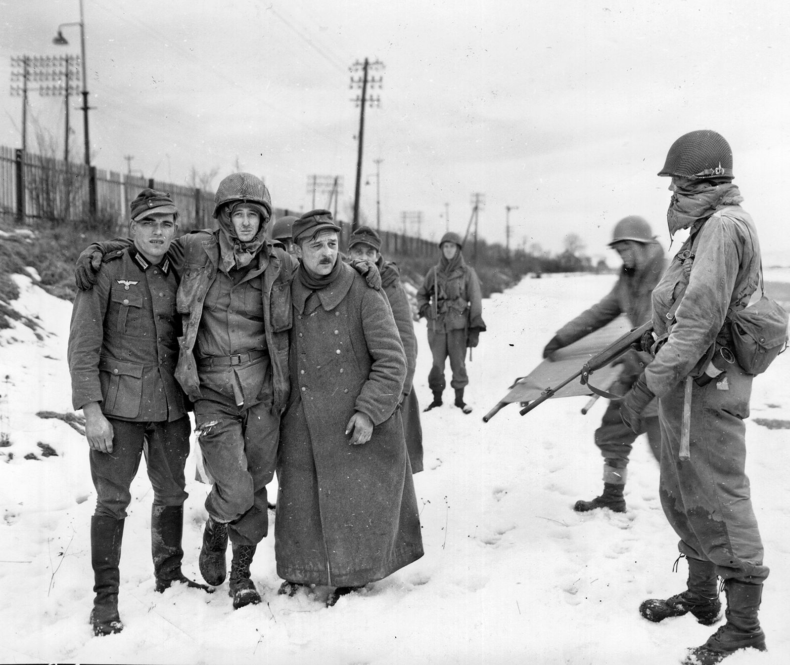 German prisoners support a wounded American soldier at the end of the offensive. The elimination of the Colmar Pocket enabled the Allies to focus exclusively on crossing the Rhine and advancing into the German heartland