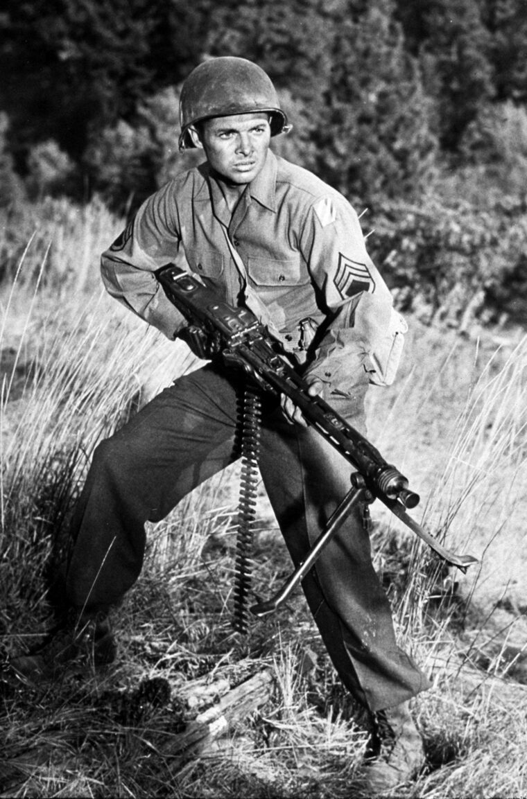 Lieutenant Audie Murphy of Company B, 1st Battalion, 15th Infantry Regiment, recreates his experiences in the Colmar Pocket offensive during the making of his autobiographical 1955 film, To Hell and Back.