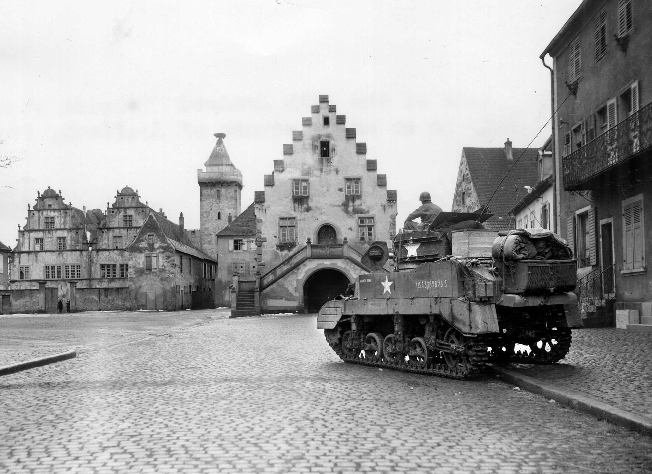 A Stuart light tank of the 12th Armored Division rolls into Rouffach, France, east of the Vosges Mountains on February 5.