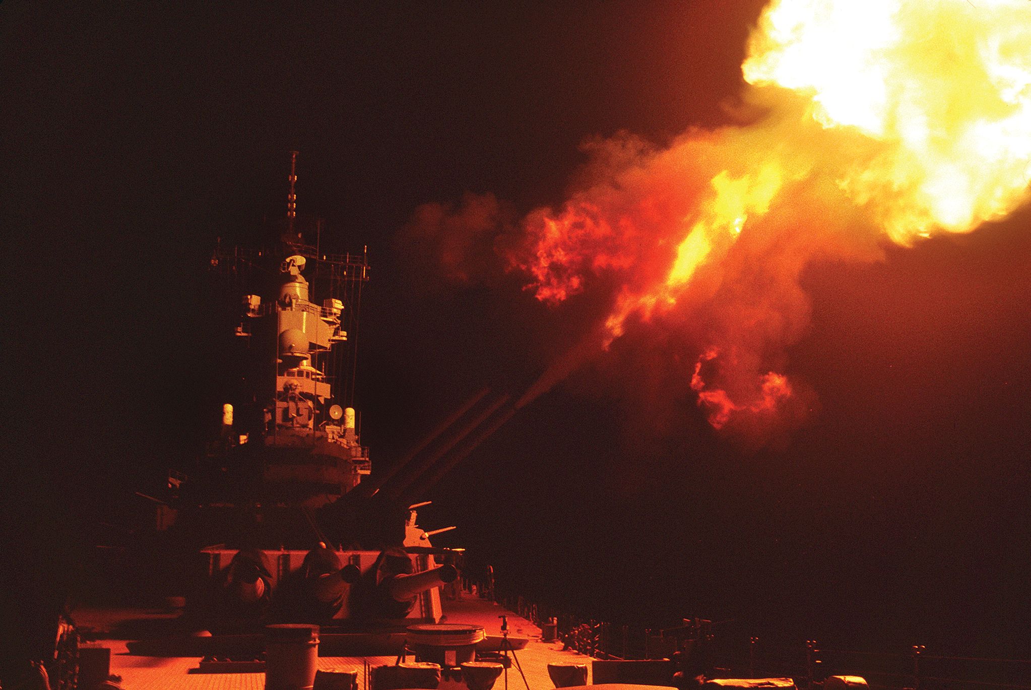 The USS Wisconsin fires her 16-inch guns at Iraqi targets near Khafji. The battleship shelled command posts, artillery batteries, infantry bunkers, and SAM sites in a series of support missions.