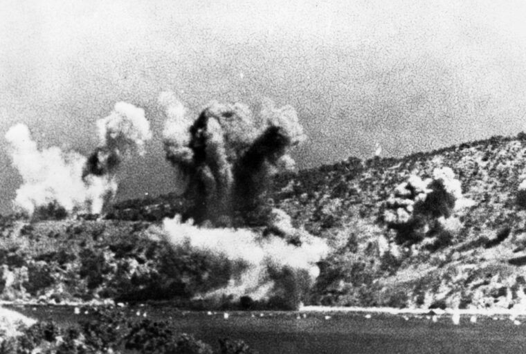 Japanese warplanes bomb Port Moresby early in the campaign.