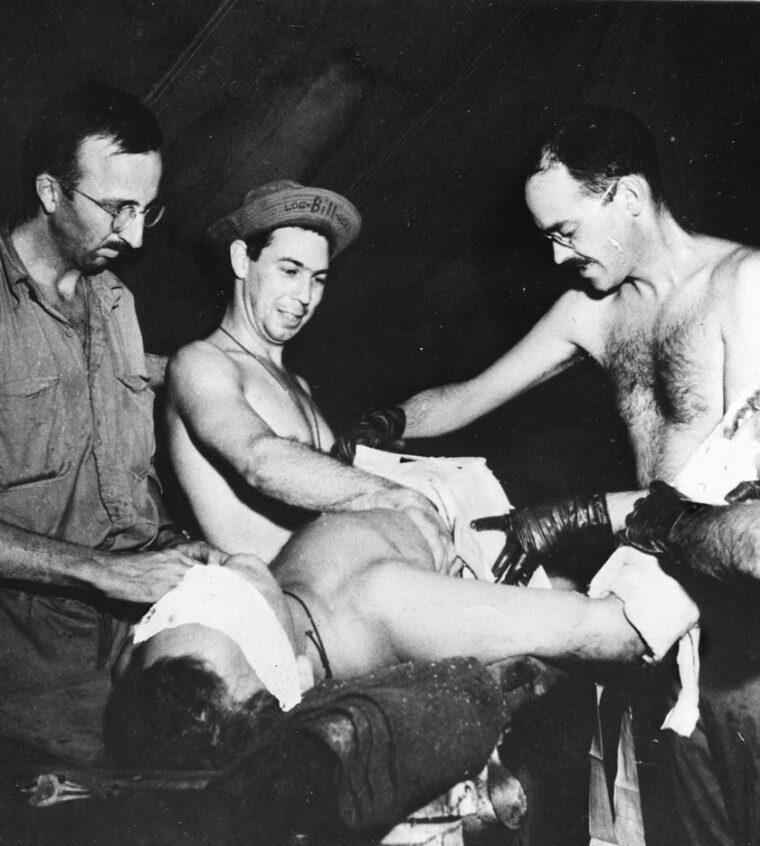 A wounded GI receives a transfusion in a Portable Surgical Hospital just behind the front lines. 