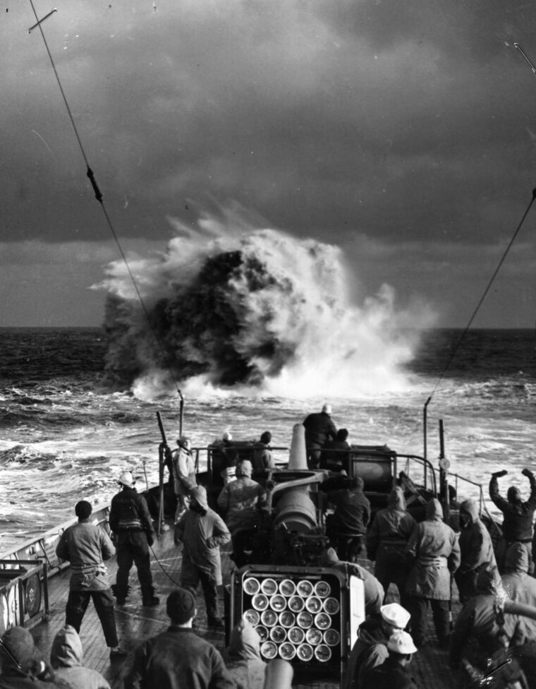 American sailors watch as the explosion of a depth charge roils the water during a drill in the North Atlantic.