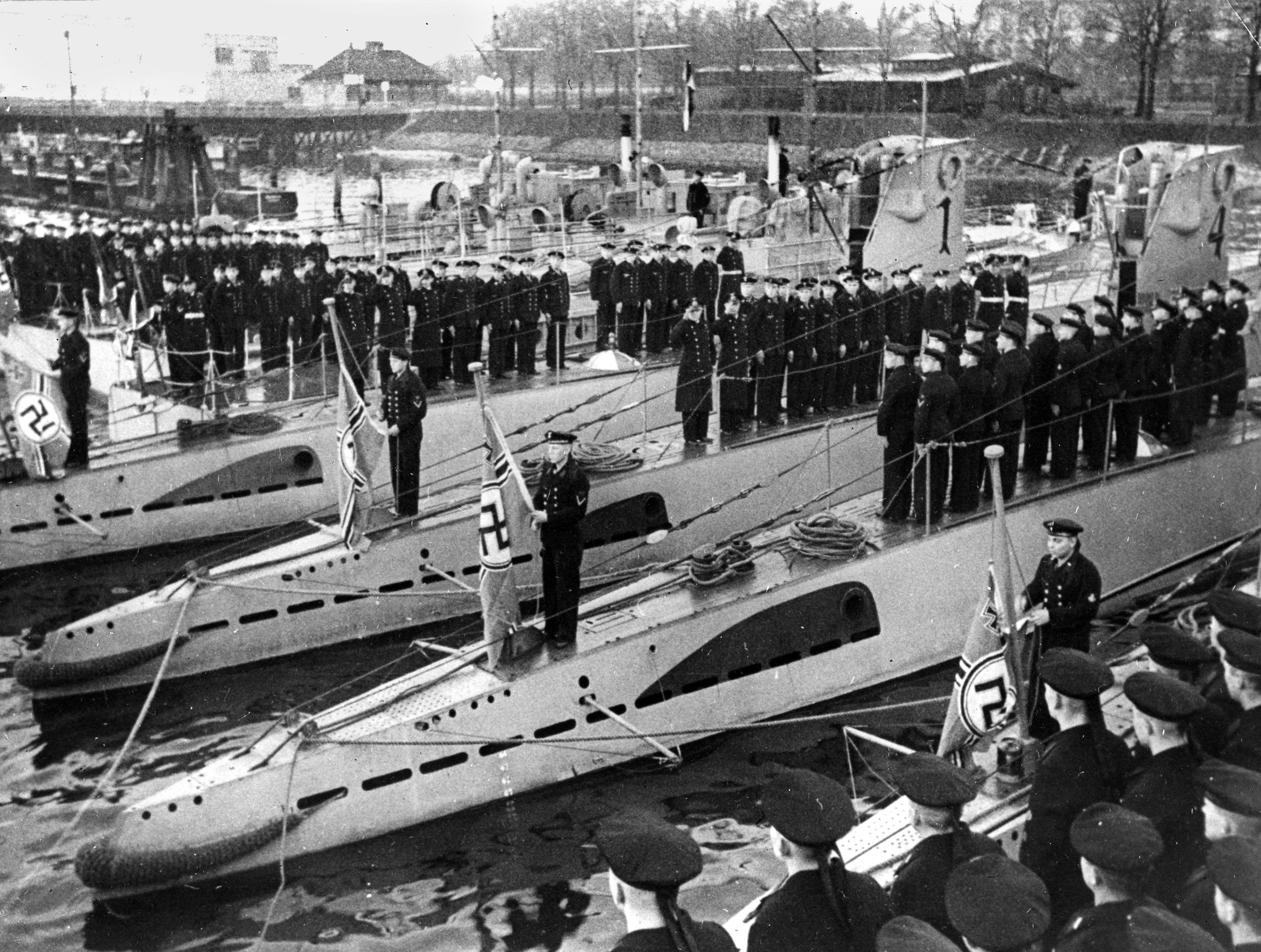 New war flags are hoisted on German submarines during a ceremony at the Kiel naval base. 
