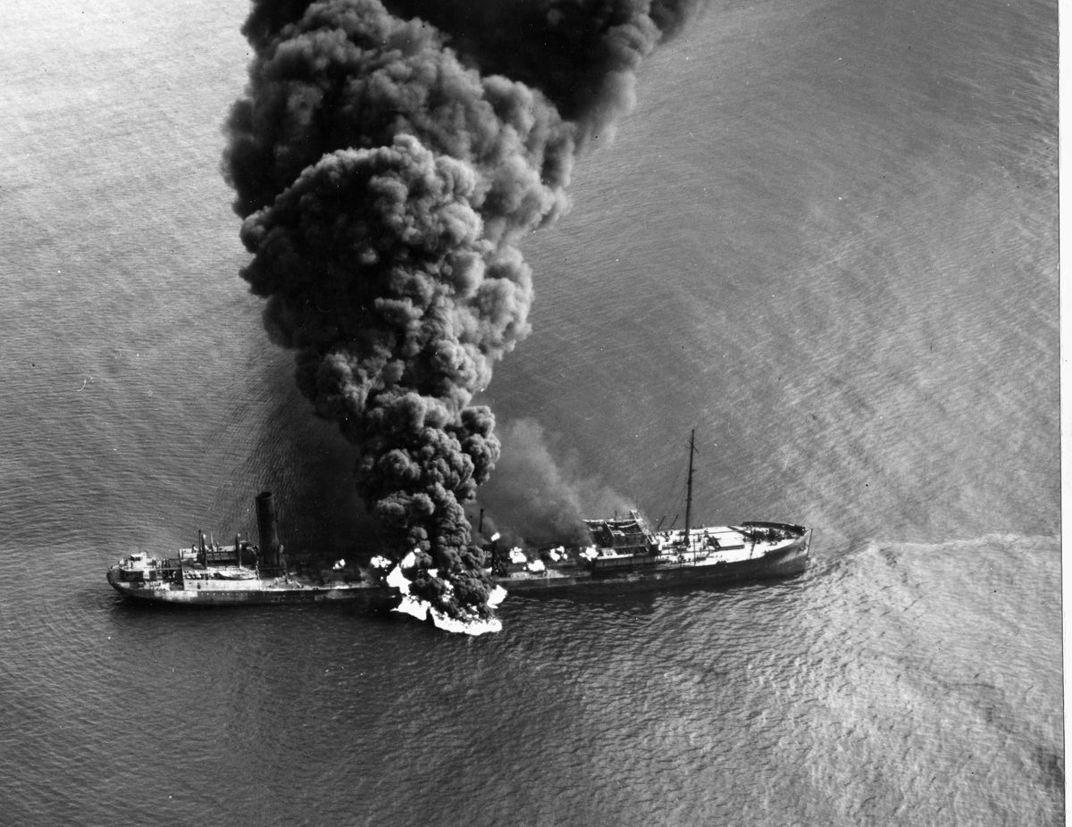 American tanker SS Byron D. Benson burns after being torpedoed off North Carolina, April 4, 1942. Ten of 37 crewmen died.
