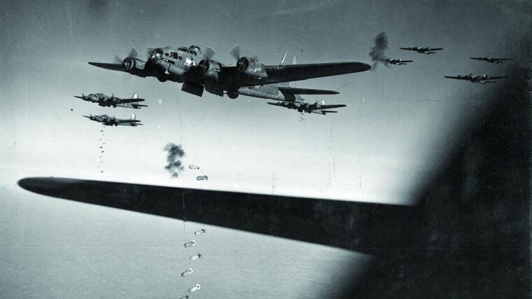 B-17 Flying Fortresses of the 390th Bomb Group drop their loads over Bremen, Germany, on November 8, 1943, as flak bursts around them.