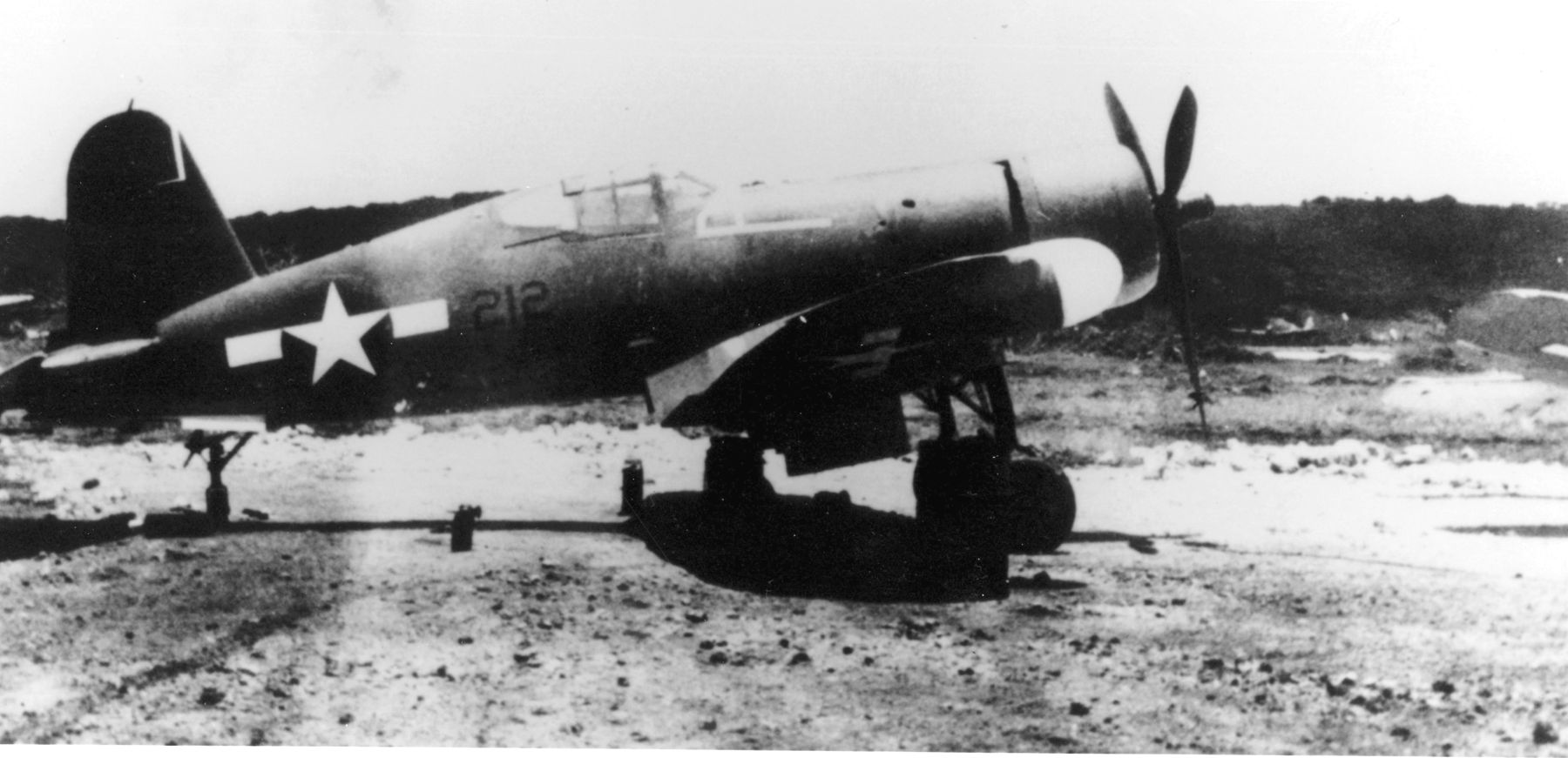 The long fuselage, distinctive gull wings, and radar installation on the right wing of the Vought F4U-2 Corsair night fighter are visible in this photograph. 