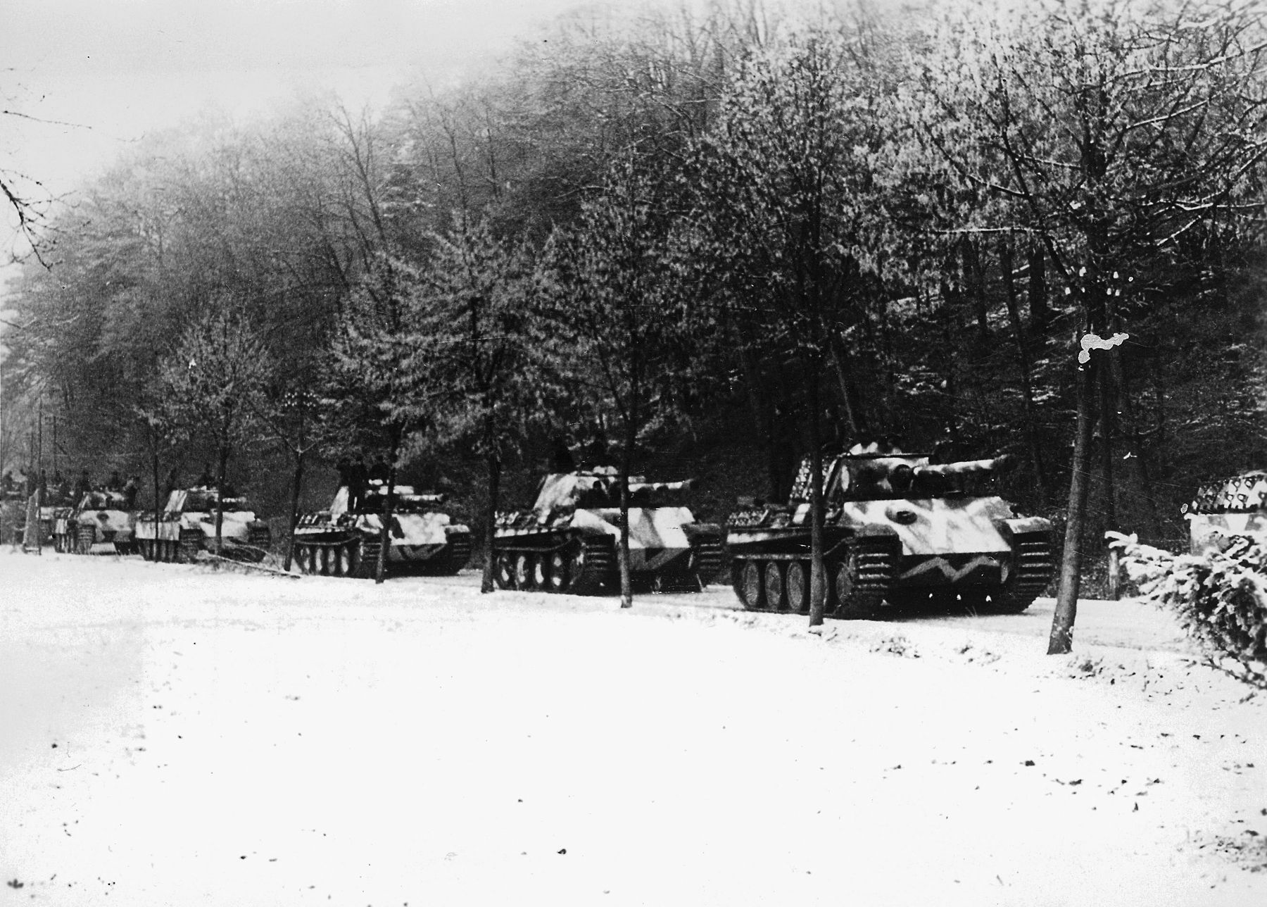 Halting along a snowy road in the Vosges Mountains of France, a column of Panther medium tanks awaits orders. The Panther was developed in response to the successful Soviet T-34 medium tank and proved to be one of the finest armored fighting vehicles of World War II.