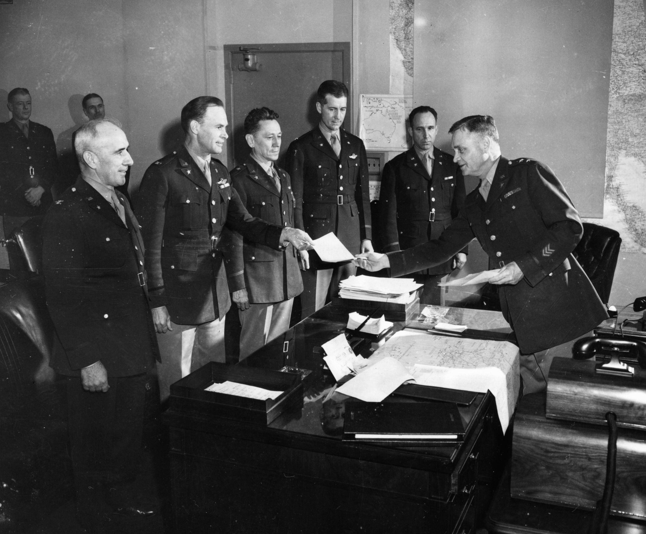 Major General Thomas T. Handy offers the general orders to one of five colonels who were promoted to the rank of brigadier general in 1943. General Handy commanded the Operations Division of  the U.S. War Department at the Pentagon. 