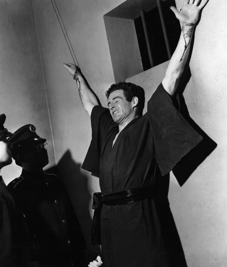 Edward Dmytryck was the first director to distinguish between the Japanese military and the Japanese people in 1943’s Behind the Rising Sun. Robert Ryan’s character, Lefty O’Doyle, takes on a Japanese soldier who intends to kill him in a boxing-martial arts match, suffers a savage beating, but prevails in the end, thus delivering the message that America will not be defeated in the war. 