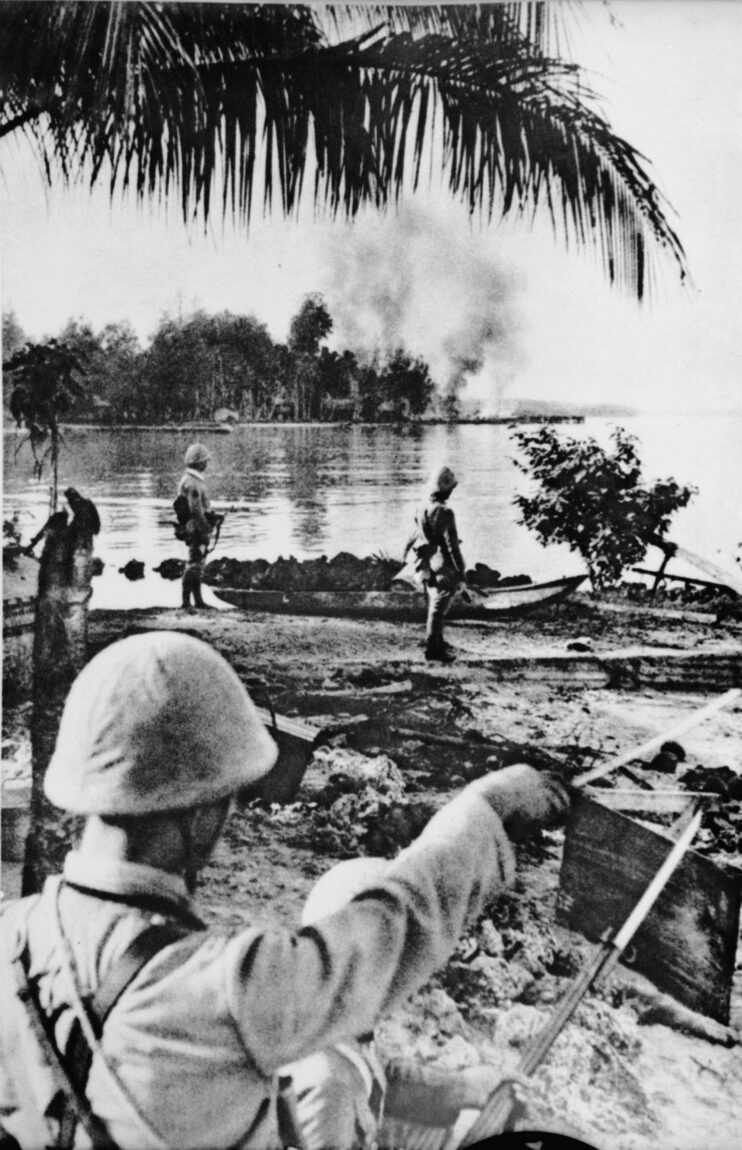 A Japanese officer with a drawn sword directs soldiers on the beach as troops occupy Kavieng, the capital of New Ireland province on the island of New Guinea. The area was captured by the Japanese on January 23, 1942, and months of hard fighting followed. 