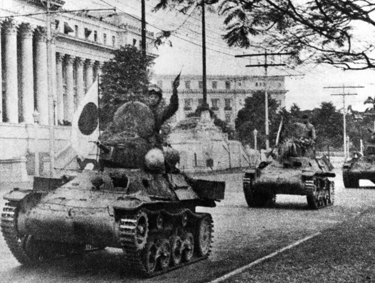 Japanese Type 97 tankettes, their crewmen flush with victory and streaming the banner of the rising sun, race past the Philippine legislature building in Manila in the opening months of World War II.