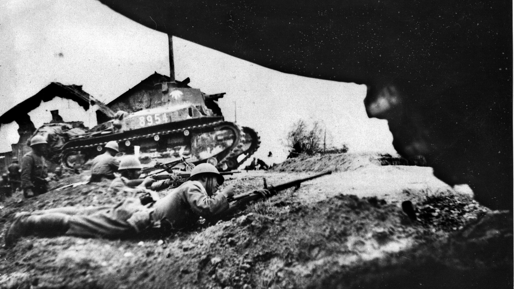 On January 5, 1939, a Japanese Type 92 combat car supports attacking infantry near the town of Nanchang, a key location in central China. 