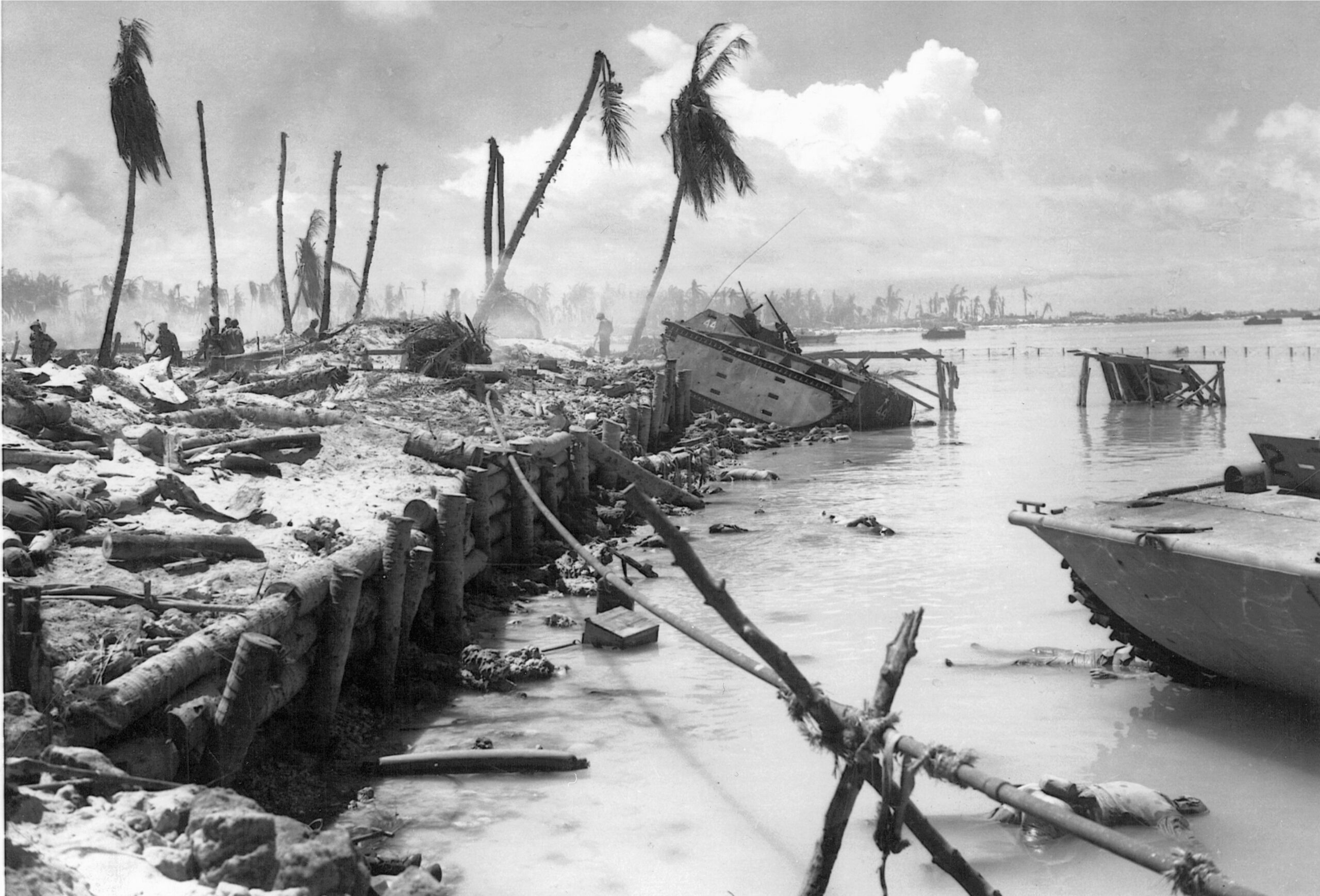 American casualties and wrecked landing craft are strewn at the seawall on Betio.