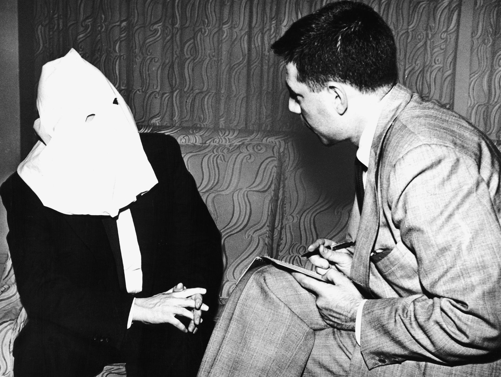 Masked to protect his identity, Igor Gouzenko, a member of the Soviet embassy staff in Ottawa, speaks to American journalist Saul Patt following his defection. Gouzenko later became a Canadian citizen.