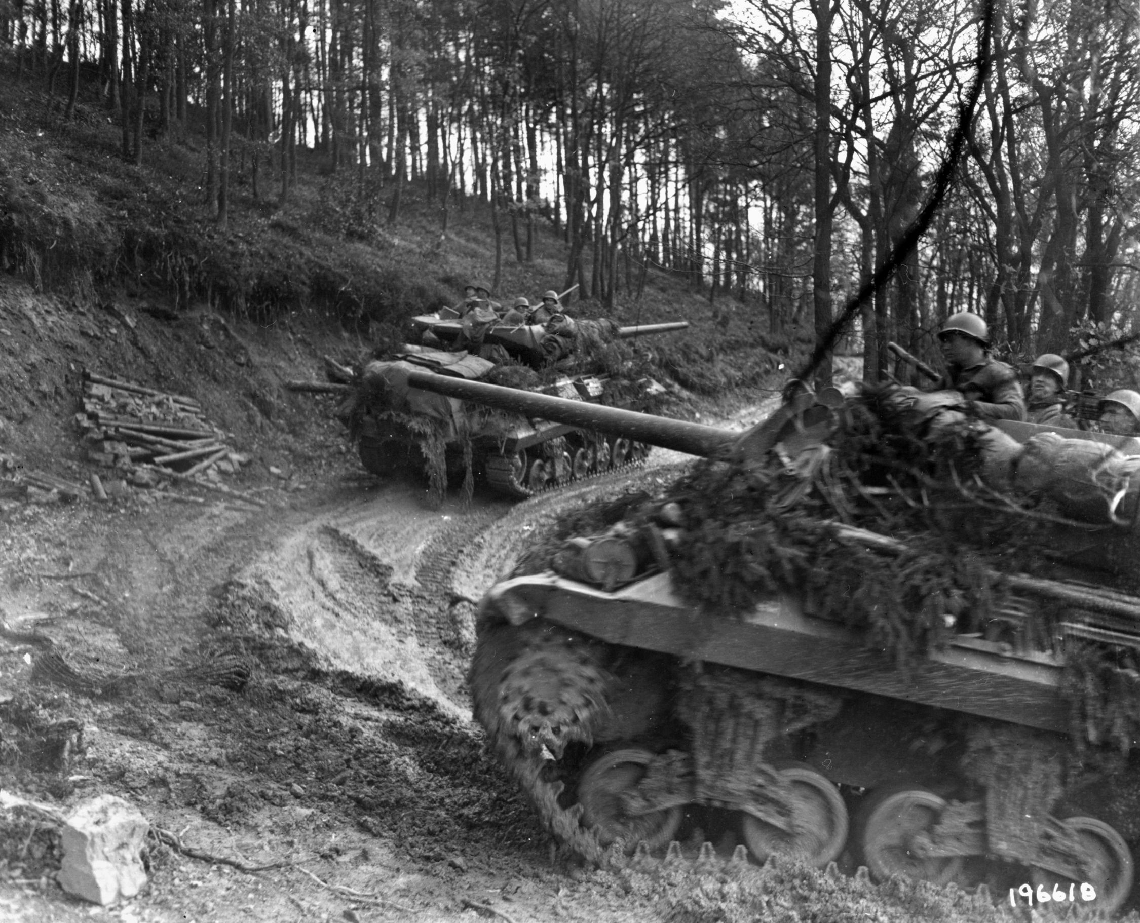 American tanks make their way cautiously up a narrow, muddy track in the Hürtgen Forest. The dense forest was difficult terrain for armor.