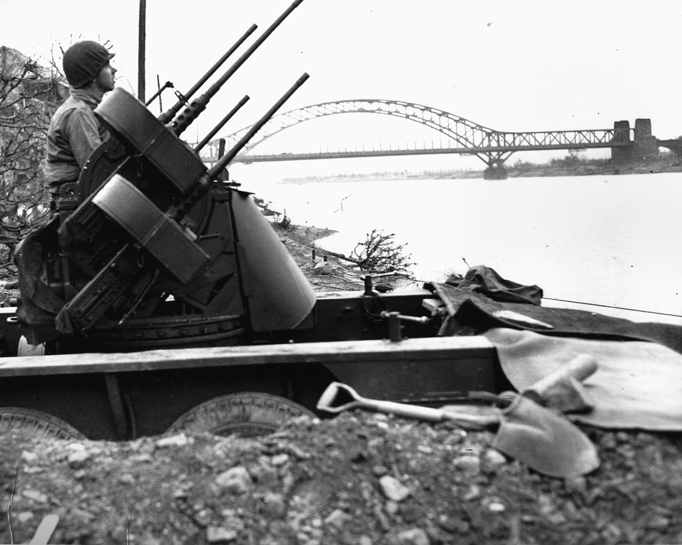 Pfc. Richard Schrame, with his quad-.50 caliber weapon, scans the skies for enemy aircraft near the Remagen bridge.