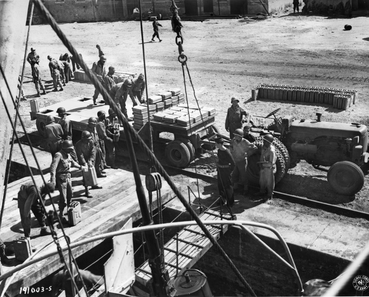 Gasoline transported across the English Channel by boat is unloaded in a canal near the French front, June 24, 1944.