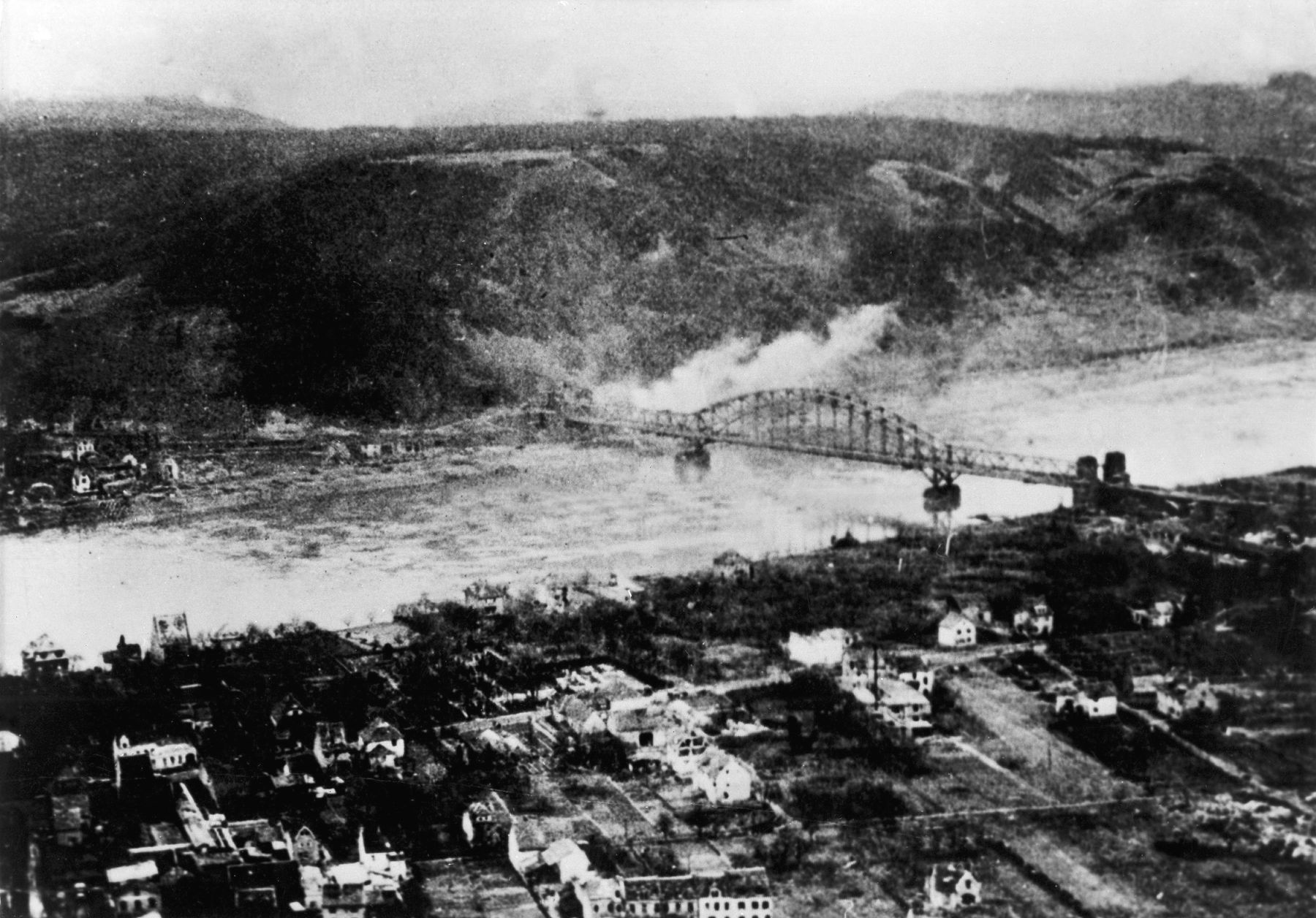After its capture on March 7, 1945, the Ludendorff Bridge is shelled by the Germans who are trying to prevent any more American First Army troops and supplies from moving across.
