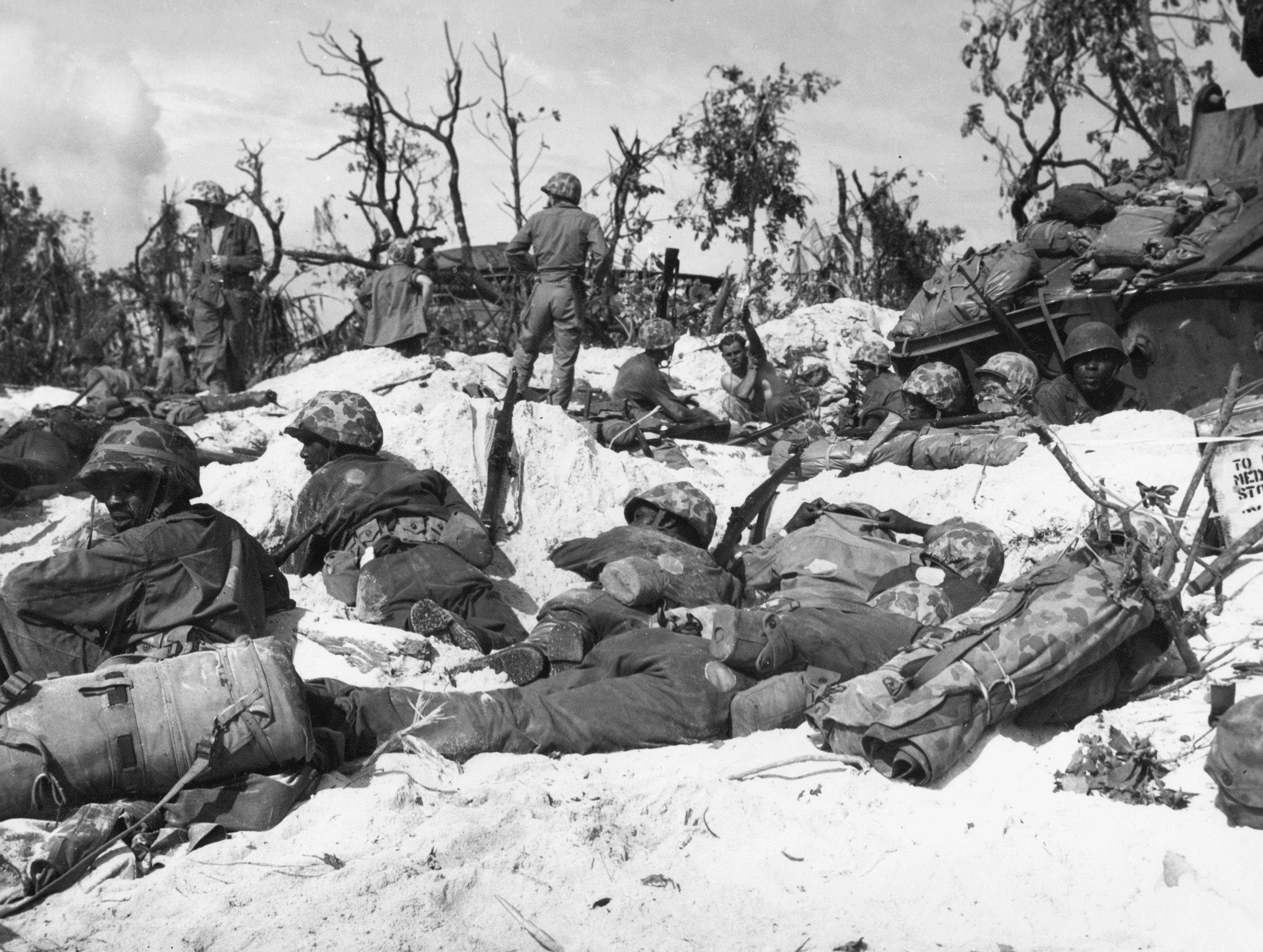 Members of an all-black Marine Corps stevedore unit take a break during a lull in the fighting for Peleliu, September 1944. 