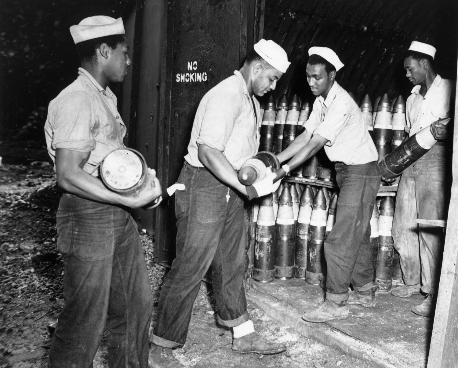 Enlisted men serving on Espiritu Santo in the New Hebrides place 6-inch shells in magazines at the Naval Ammunition Depot. 