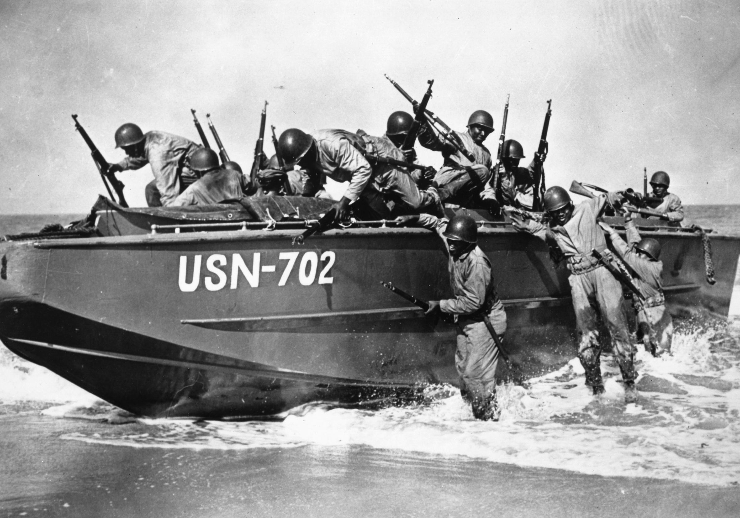 Members of an all-black Seabee battalion practice disembarking from an LCP(L) (Landing Craft Personnel, Large), December 1942.