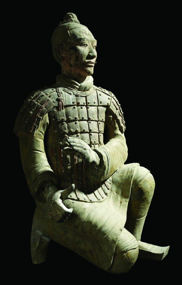 A kneeling archer, which is on view at the High Museum, wears heavy armor on his shoulders and torso. 