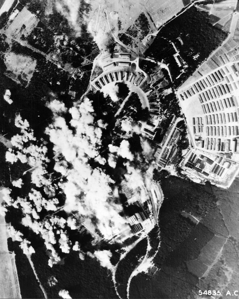 The explosions of bombs dropped by U.S. Army Air Forces planes on a weapons factory near Buchenwald concentration camp on August 24, 1944, demonstrate the precision capabilities of the bombardiers. This may have caused the Germans to suspend mail privileges.